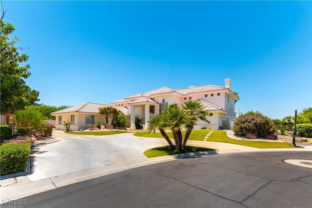 2019 Doral Ct, Henderson, NV 89074 - mediterranean / spanish-style house featuring a chimney, stucco siding, a tiled roof, and curved driveway