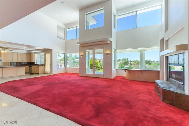 2019 Doral Ct, Henderson, NV 89074 - living room with a towering ceiling, a fireplace, light carpet, ceiling fan, and light tile patterned floors