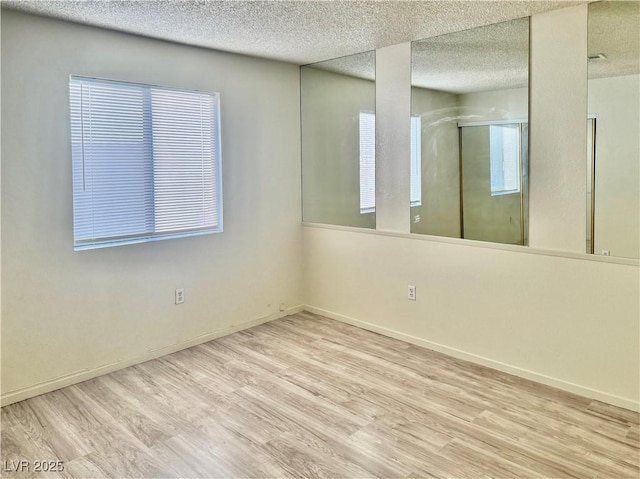 805 Rock Springs Dr Unit 101, Las Vegas, NV 89128 - unfurnished room featuring wood finished floors and a textured ceiling
