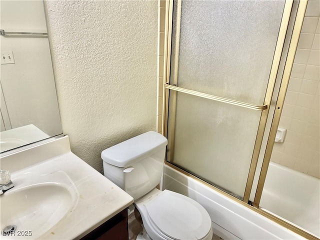 805 Rock Springs Dr Unit 101, Las Vegas, NV 89128 - full bathroom featuring a textured wall, vanity, and combined bath / shower with glass door