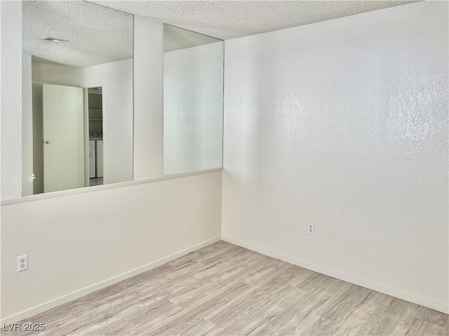 805 Rock Springs Dr Unit 101, Las Vegas, NV 89128 - spare room featuring wood finished floors and a textured ceiling