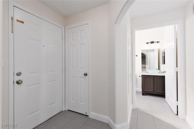 1609 Hills Of Red Dr Unit 104, Las Vegas, NV 89128 - foyer entrance with arched walkways and light tile patterned floors