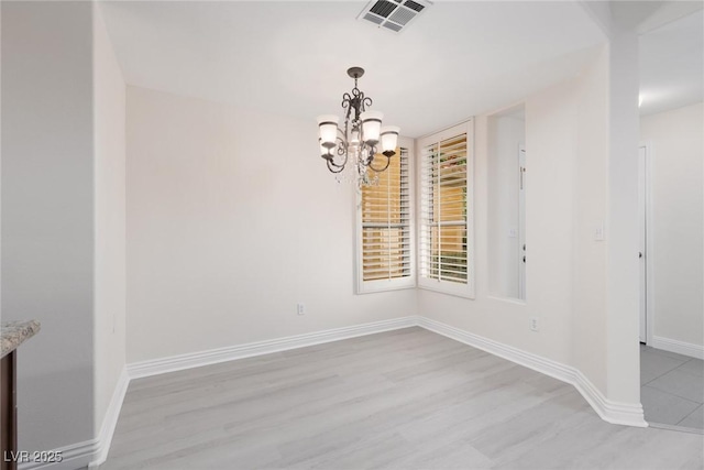 1609 Hills Of Red Dr Unit 104, Las Vegas, NV 89128 - unfurnished dining area with a chandelier and light wood-style floors