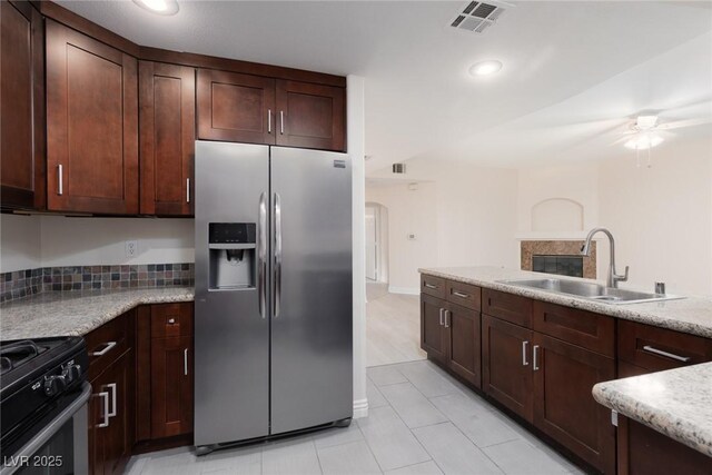 1609 Hills Of Red Dr Unit 104, Las Vegas, NV 89128 - kitchen featuring stainless steel fridge, black gas range oven, a ceiling fan, recessed lighting, and arched walkways