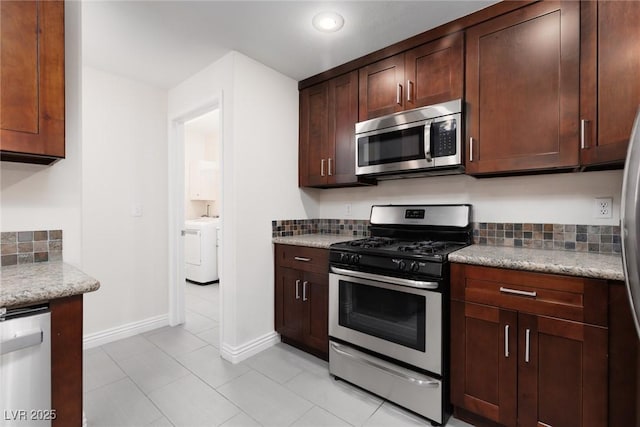 1609 Hills Of Red Dr Unit 104, Las Vegas, NV 89128 - kitchen featuring appliances with stainless steel finishes, washer and clothes dryer, backsplash, light tile patterned floors, and recessed lighting