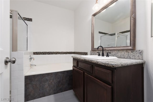 1609 Hills Of Red Dr Unit 104, Las Vegas, NV 89128 - full bath featuring a bath, a shower stall, vanity, and tile patterned flooring