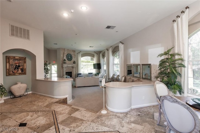 1609 Hills Of Red Dr Unit 104, Las Vegas, NV 89128 - full bathroom with a freestanding tub, a fireplace, stone tile flooring, and recessed lighting