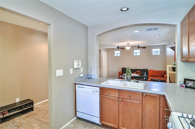9068 Alluring Ave, Las Vegas, NV 89149 - kitchen featuring white appliances, arched walkways, brown cabinetry, a ceiling fan, and recessed lighting