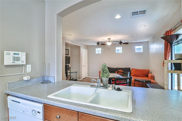 9068 Alluring Ave, Las Vegas, NV 89149 - kitchen with dishwasher, arched walkways, light countertops, recessed lighting, and a ceiling fan