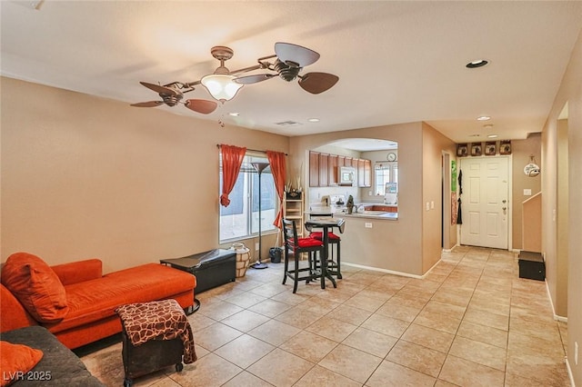 9068 Alluring Ave, Las Vegas, NV 89149 - dining area featuring ceiling fan, light tile patterned floors, arched walkways, and recessed lighting