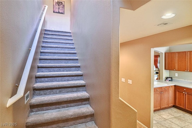9068 Alluring Ave, Las Vegas, NV 89149 - staircase with tile patterned flooring and a textured wall