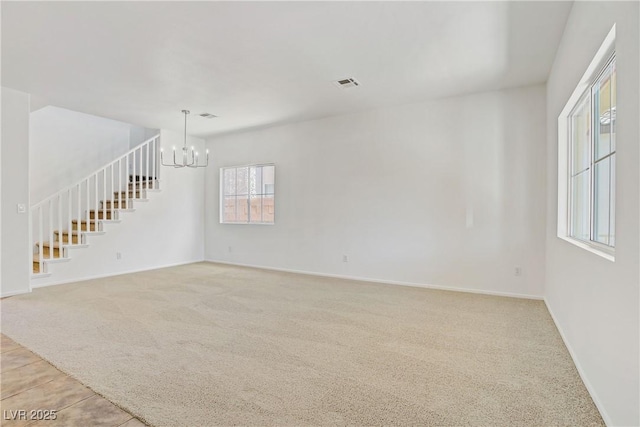1208 Silver Bark Ave, North Las Vegas, NV 89081 - unfurnished living room featuring a chandelier, light colored carpet, and stairs