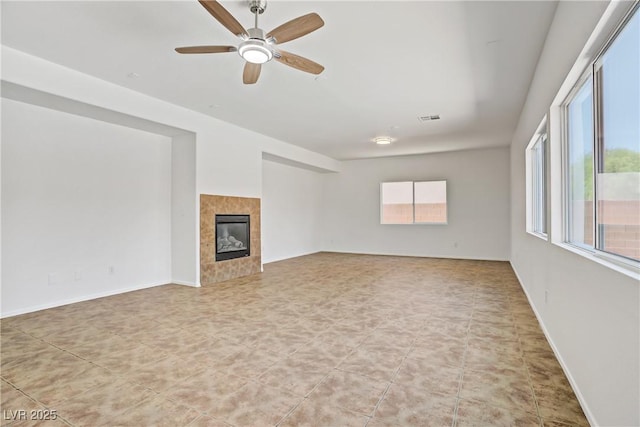 1208 Silver Bark Ave, North Las Vegas, NV 89081 - unfurnished living room with a tile fireplace and a ceiling fan