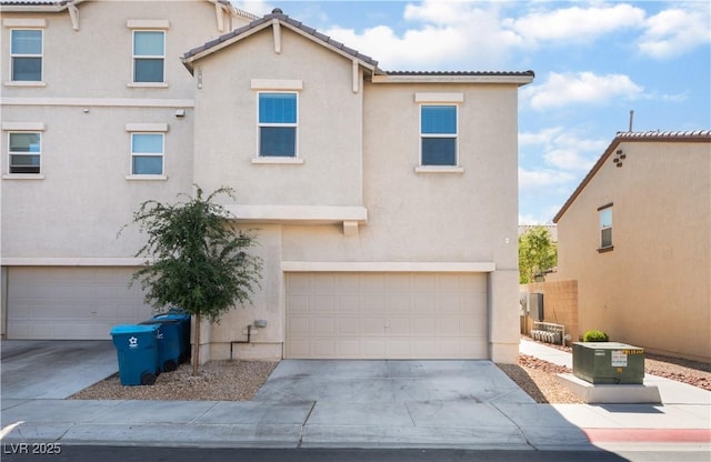 4588 Dover Straight St, Las Vegas, NV 89115 - view of front facade featuring an attached garage, stucco siding, concrete driveway, and a tile roof
