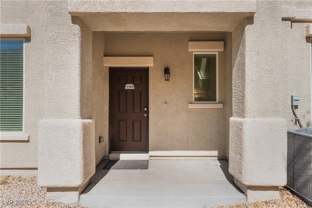 4588 Dover Straight St, Las Vegas, NV 89115 - doorway to property featuring stucco siding