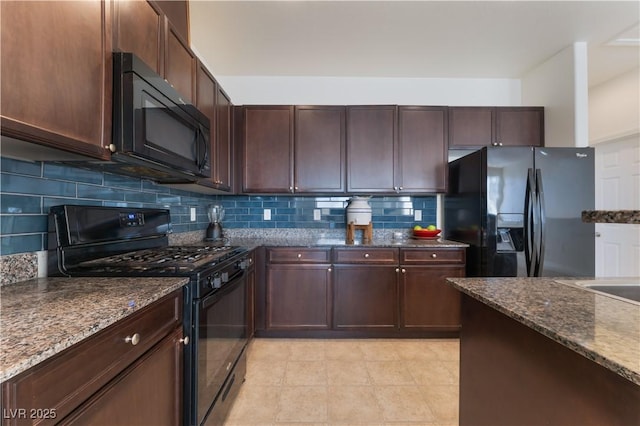 4588 Dover Straight St, Las Vegas, NV 89115 - kitchen with black appliances, decorative backsplash, dark stone countertops, light tile patterned flooring, and dark brown cabinetry