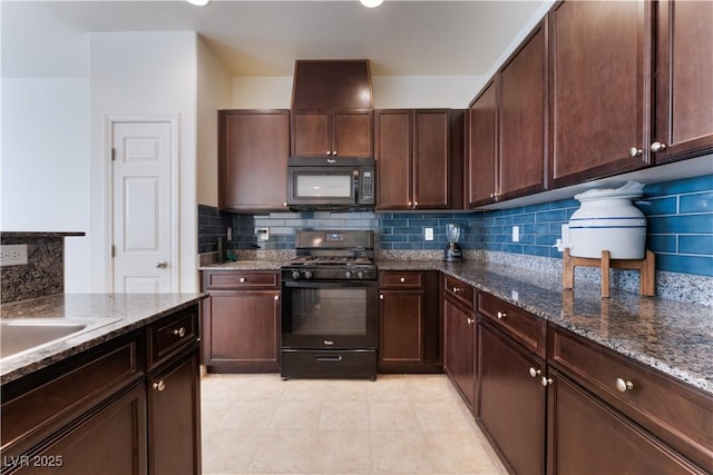 4588 Dover Straight St, Las Vegas, NV 89115 - kitchen featuring black appliances, tasteful backsplash, dark stone counters, and dark brown cabinetry