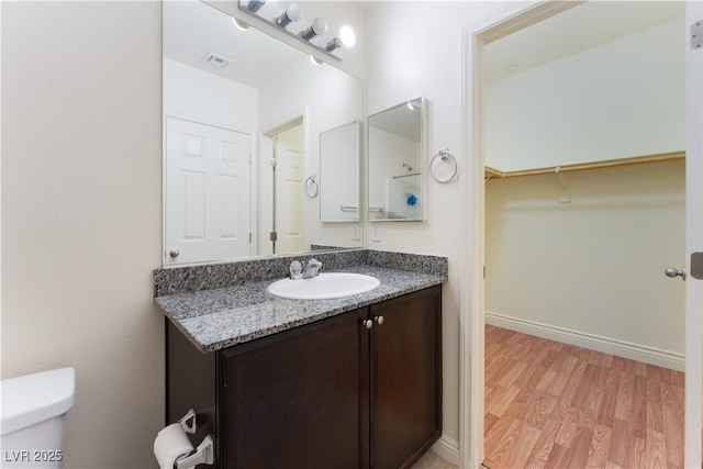 4588 Dover Straight St, Las Vegas, NV 89115 - bathroom featuring vanity, wood finished floors, and a walk in closet