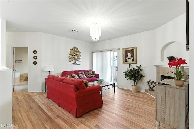 1713 Sky Of Red Dr Unit 201, Las Vegas, NV 89128 - living area with light wood-type flooring, a chandelier, and a fireplace