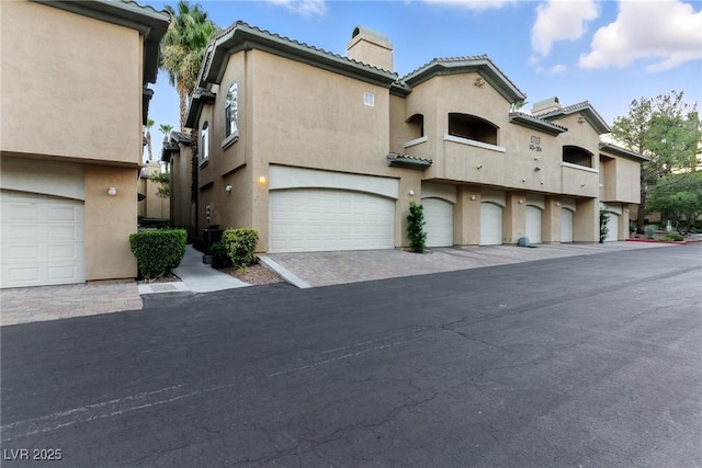 1713 Sky Of Red Dr Unit 201, Las Vegas, NV 89128 - mediterranean / spanish-style house featuring a chimney, a tile roof, and stucco siding