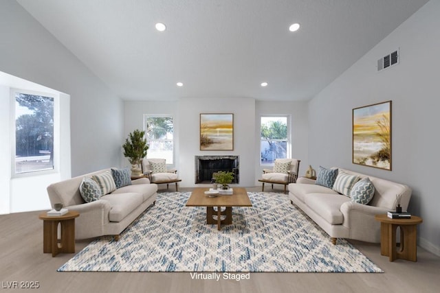 714 Lacy Ln, Las Vegas, NV 89107 - living room featuring vaulted ceiling, a fireplace, recessed lighting, and wood finished floors
