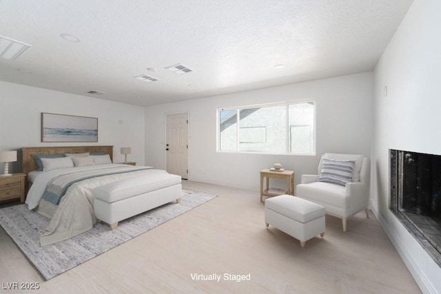 714 Lacy Ln, Las Vegas, NV 89107 - bedroom with a textured ceiling and light wood finished floors