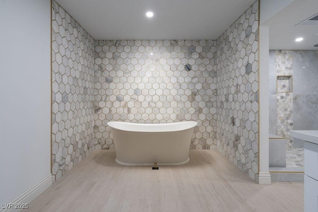 714 Lacy Ln, Las Vegas, NV 89107 - full bathroom featuring tile walls, a freestanding tub, recessed lighting, and a shower
