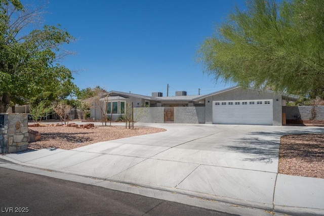 714 Lacy Ln, Las Vegas, NV 89107 - view of front facade featuring driveway, an attached garage, and stucco siding