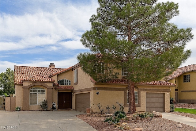 32 Stone Cress Dr, Henderson, NV 89074 - mediterranean / spanish-style home with concrete driveway, a tiled roof, stucco siding, a chimney, and an attached garage