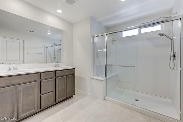 4133 Golden Fleece Ave, Las Vegas, NV 89141 - bathroom featuring a stall shower, double vanity, tile patterned flooring, and recessed lighting