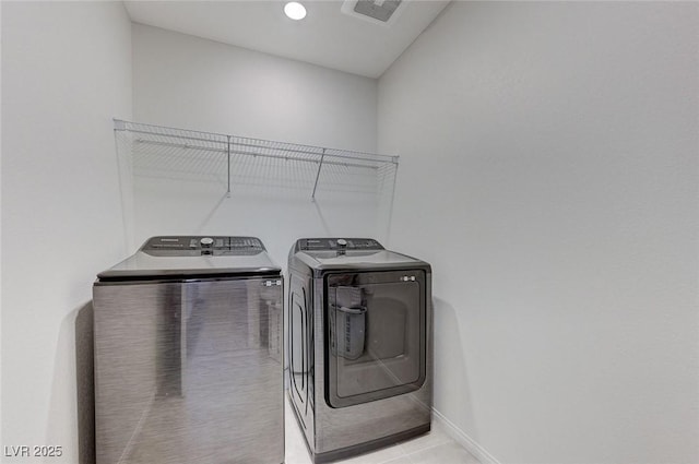 4133 Golden Fleece Ave, Las Vegas, NV 89141 - laundry room with washer and clothes dryer and light tile patterned flooring