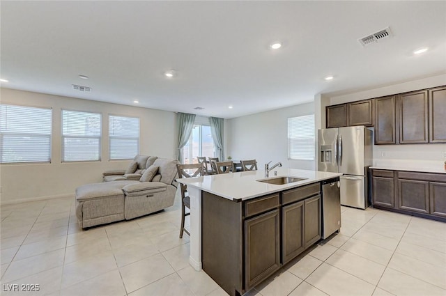 4133 Golden Fleece Ave, Las Vegas, NV 89141 - kitchen with stainless steel appliances, dark brown cabinets, recessed lighting, light tile patterned floors, and light countertops