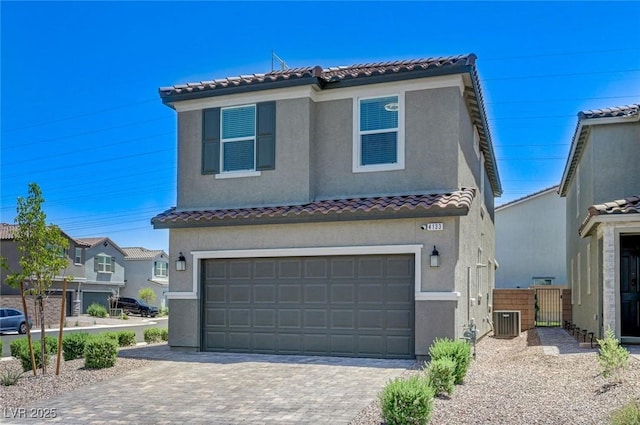 4133 Golden Fleece Ave, Las Vegas, NV 89141 - mediterranean / spanish house featuring stucco siding, decorative driveway, a tile roof, an attached garage, and a gate