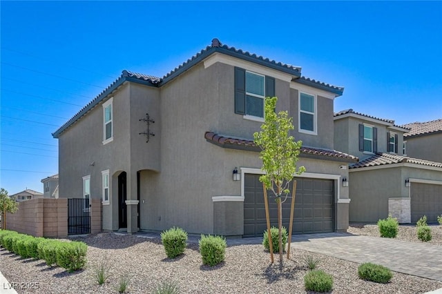 4133 Golden Fleece Ave, Las Vegas, NV 89141 - mediterranean / spanish-style house with a garage, a tile roof, stucco siding, decorative driveway, and a gate
