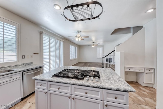 208 Glendon St, Henderson, NV 89074 - kitchen with stainless steel appliances, light tile patterned floors, a ceiling fan, light countertops, and recessed lighting