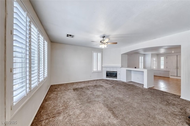 208 Glendon St, Henderson, NV 89074 - unfurnished living room with carpet flooring, healthy amount of natural light, ceiling fan, and a fireplace