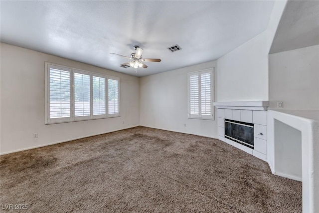 208 Glendon St, Henderson, NV 89074 - unfurnished living room featuring plenty of natural light, a ceiling fan, a tiled fireplace, and carpet