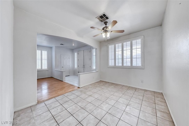 208 Glendon St, Henderson, NV 89074 - spare room featuring a ceiling fan, arched walkways, and light tile patterned flooring