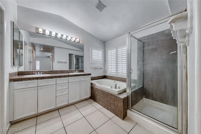 208 Glendon St, Henderson, NV 89074 - full bath with vaulted ceiling, double vanity, tile patterned floors, a bath, and a stall shower