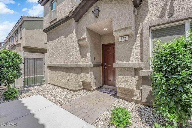 4650 Blaise Ave Unit 102, North Las Vegas, NV 89084 - property entrance featuring stucco siding and a gate