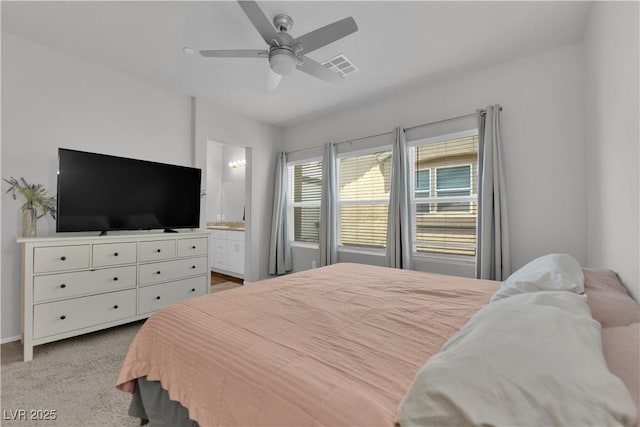 4650 Blaise Ave Unit 102, North Las Vegas, NV 89084 - bedroom with carpet, connected bathroom, and a ceiling fan