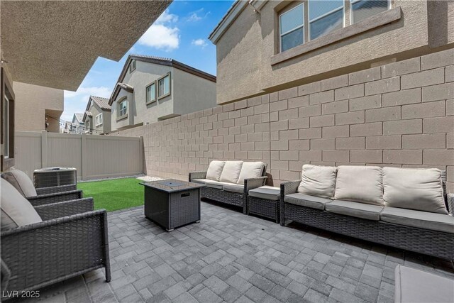 4650 Blaise Ave Unit 102, North Las Vegas, NV 89084 - fenced backyard featuring an outdoor living space and a patio area