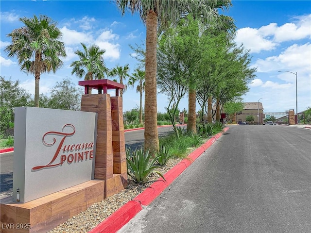 4650 Blaise Ave Unit 102, North Las Vegas, NV 89084 - view of asphalt road featuring curbs, street lighting, and a gated entry