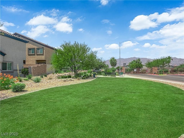 4650 Blaise Ave Unit 102, North Las Vegas, NV 89084 - view of green lawn featuring a mountain view