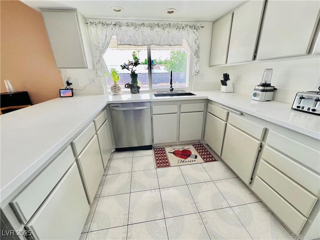 421 Courtney Ln, Las Vegas, NV 89107 - kitchen featuring stainless steel dishwasher, light countertops, and light tile patterned floors