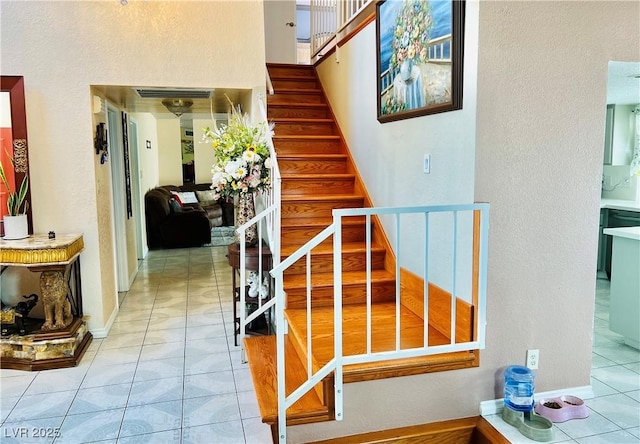 421 Courtney Ln, Las Vegas, NV 89107 - staircase featuring tile patterned floors and a textured wall