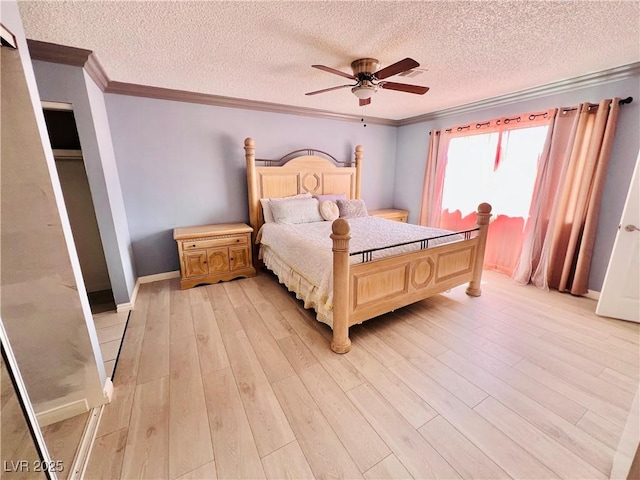421 Courtney Ln, Las Vegas, NV 89107 - bedroom featuring ornamental molding, light wood-style flooring, a textured ceiling, and a ceiling fan