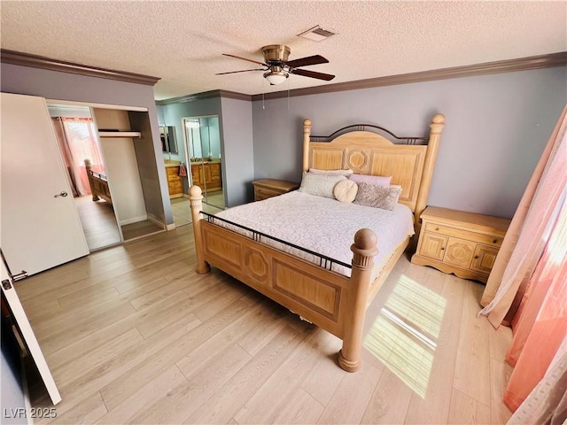 421 Courtney Ln, Las Vegas, NV 89107 - bedroom with ornamental molding, light wood-style flooring, a textured ceiling, ceiling fan, and connected bathroom