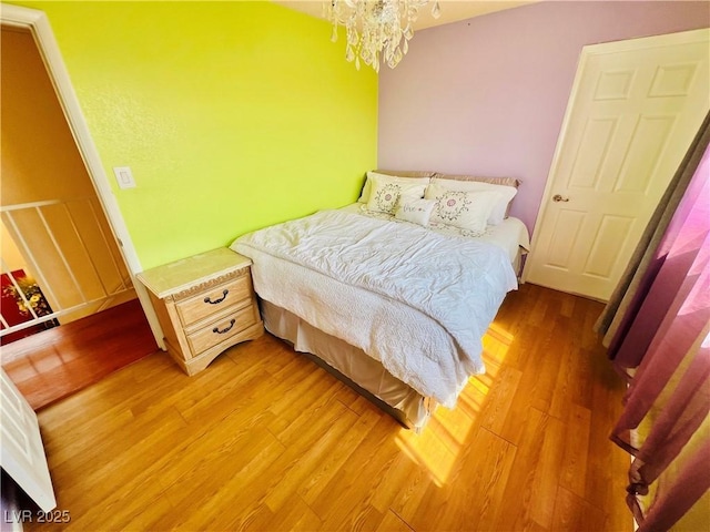 421 Courtney Ln, Las Vegas, NV 89107 - bedroom featuring light wood finished floors and a chandelier
