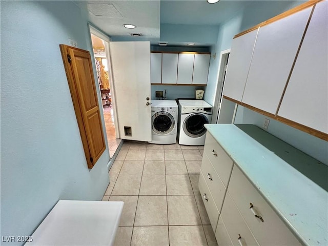 421 Courtney Ln, Las Vegas, NV 89107 - washroom featuring washing machine and clothes dryer, cabinet space, and light tile patterned floors